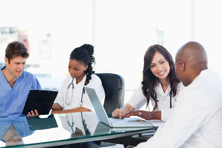 nurses sitting around a table