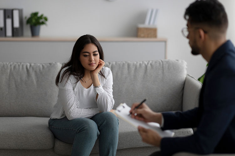 Male counselor chatting with a female patient