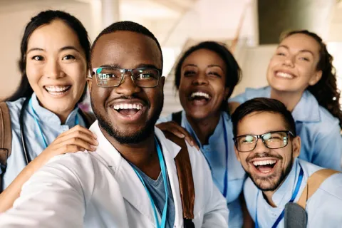 five smiling nurse practitioners